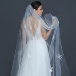 931-100

100” (108”) flutter cut veil scattered with hand embroidered floral appliqués throughout, accented with pearls, seed beads & lochrosens on a silver comb…….. (Diamond white, ivory or white )…………….