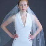 934-40

40” long (108”) cut edge veil with scattered 4mm pearls along the edge on a silver comb…(Ivory or white pearls)…All tulle colors