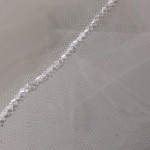 950-42

42” long (108”) single tier with a diagonal seed bead edge on a silver comb…. (Silky silver bead only) Diamond white, ivory or white tulle…………………