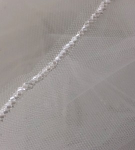  950-42 42” long (108”) single tier with a diagonal seed bead edge on a silver comb…. (Silky silver bead only) Diamond white, ivory or white tulle…………………