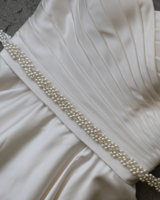 B-132

32” appliqué of assorted pearls and lochrosen stones tipped with crystals….(Ivory or white pearl)…..